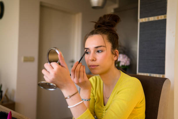 istock Young woman doing make up at home. 1476004184