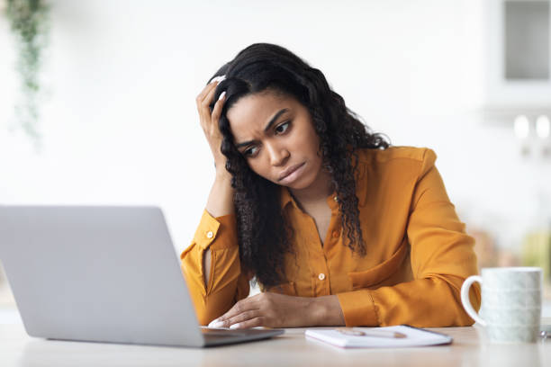 istock Upset black lady freelancer working on laptop at home 1476004216