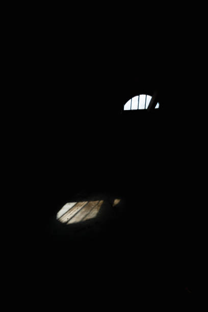 istock A very dark room with a small window through which sunlight enters the floor 1476004862
