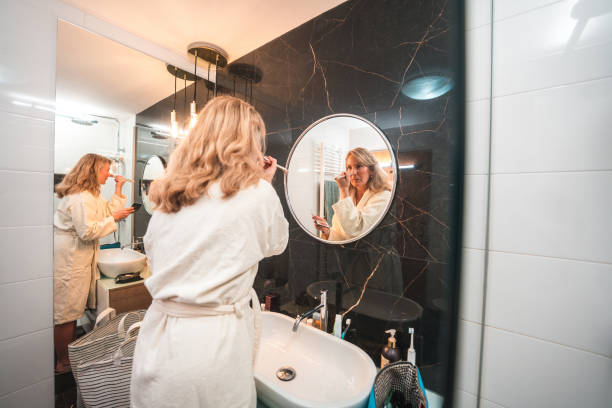 istock Handsome Mature Caucasian Female Doing Her Makeup 1476011682