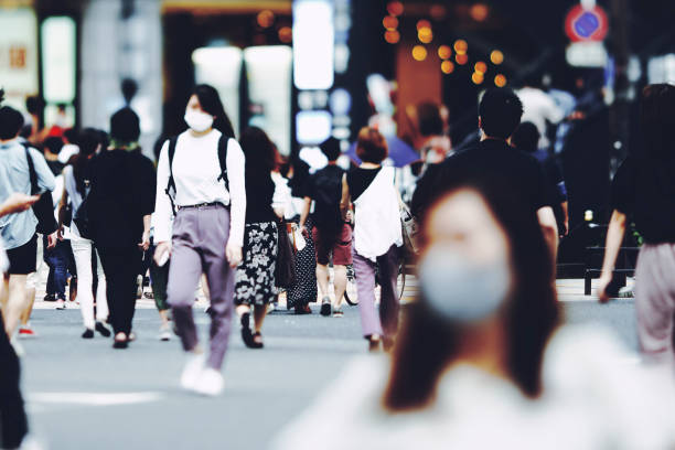 istock Many people walking in the downtown area 1476013829