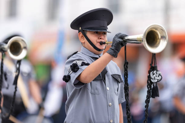 Valle Hermoso, Tamaulipas, Mexico - March 18, 2023: City Anniversary Parade, Members of the  Marching band from the Lic. Adolfo Lopez Mateos, middle school, performing at the parade