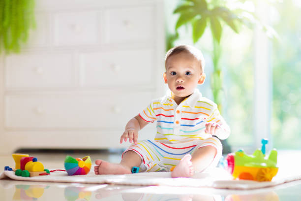 istock Baby boy playing with toy 1476016434