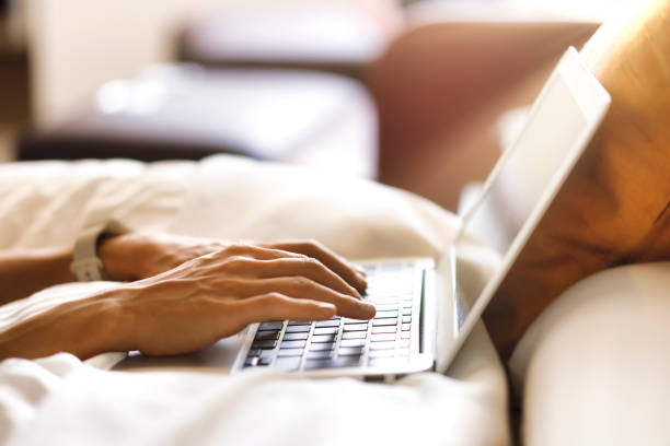 istock Woman operating a laptop in the bedroom 1476016655
