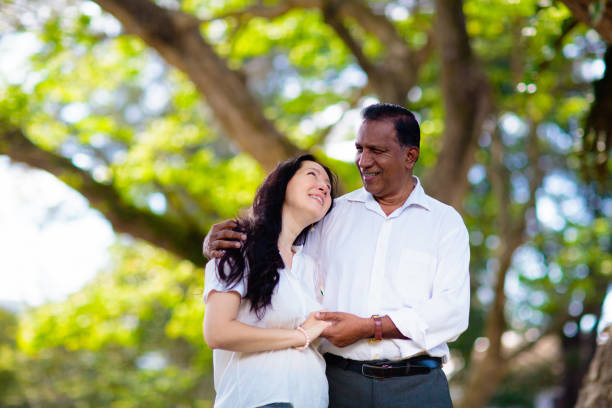 istock Interracial couple in summer park. 1476018397