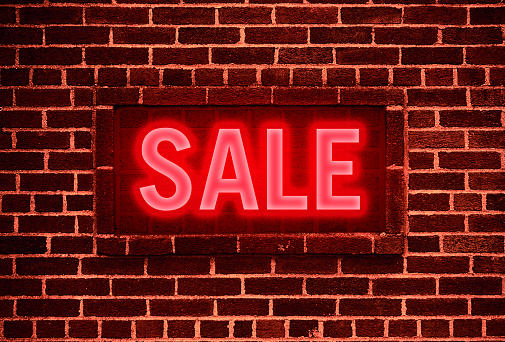 Sale Neon sign on a brick wall