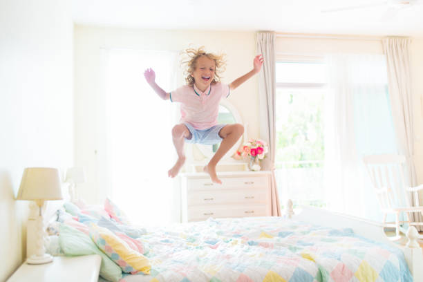 istock Child playing in bed. Kids room. Boy at home. 1476019471