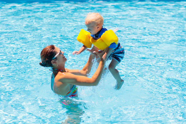 istock Mother and baby in swimming pool 1476020004