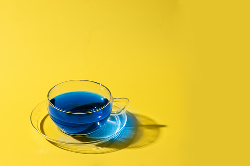 Butterfly pea flower  or blue tea cup on yellow background. Ayurvedic herbal beverage for rejuvenates the skin  and anti-aging effect