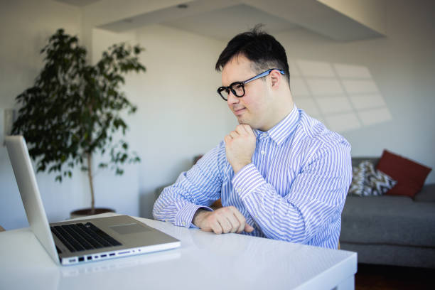 Smiling young man freelancer using laptop studying online working from home.