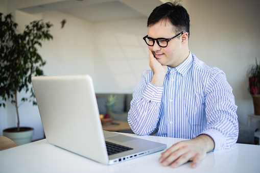 Portrait of a young man working from his home