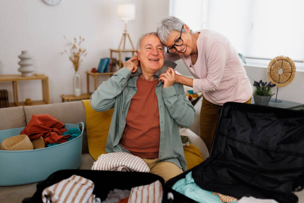 istock Senior couple having affectionate moment while packing for a trip in their apartment 1476022811