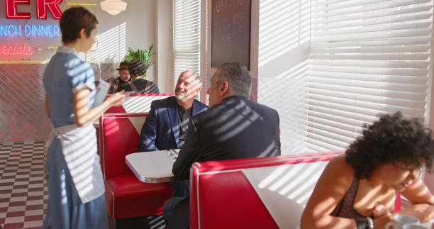 istock Waitress Taking Order For Two Mature Men In 1950s Styled Diner 1476022844