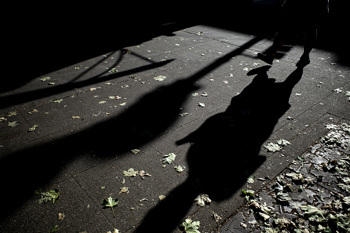 Shadows and lines with an unrecognizable travelers.