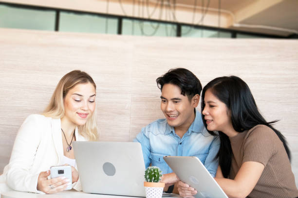 istock Full concentration at work. Multi-ethnic business people sitting and discussing in the office, best collaboration concept for work 1476025988