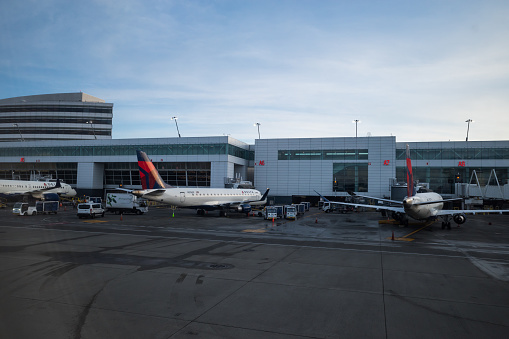 Seattle, USA - Mar 5, 2023: A Delta airlines plane at SeaTac late in the day at a gate.
