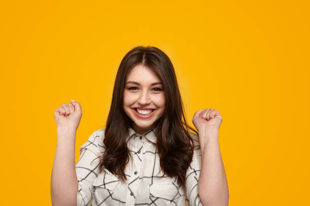 istock Merry young brunette celebrating victory 1476041509