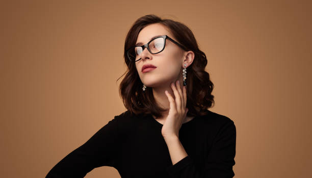 Elegant young woman touching neck stock photo