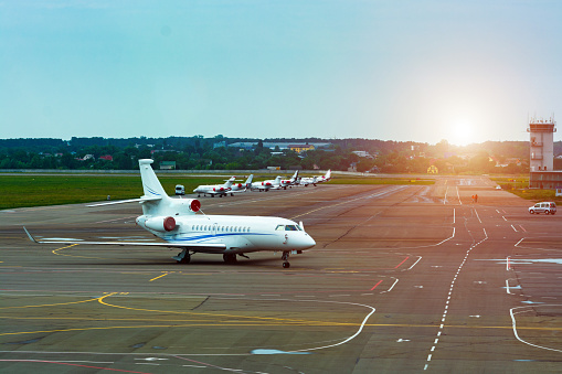 A small passenger plane is on the runway at the airport.