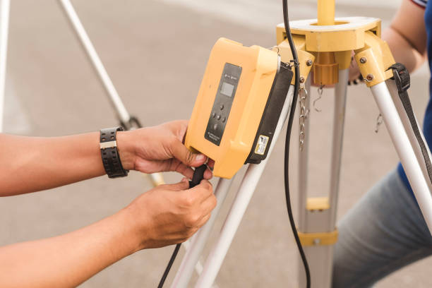 istock A surveyor setting up a wireless data transceiver. Surveying equipment used in the field. 1476054918