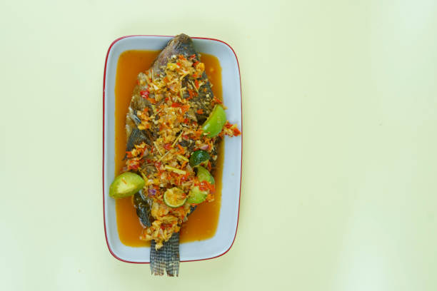 Pecak Ikan Mujair or Tialipa fish is a traditional Indonesian dish that originated from Betawi, Indonesia. stock photo