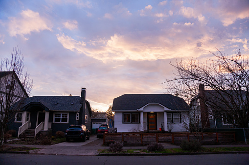 Residential neighborhood in Portland Oregon, shot with the houses backlit from the sunset.