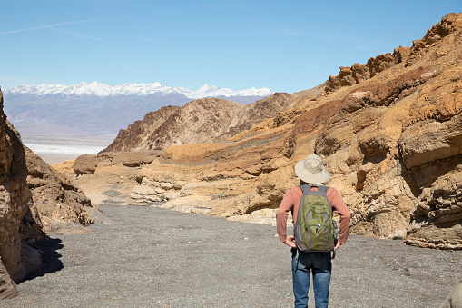 Senior man hiking in Death Valley, California, looking at view