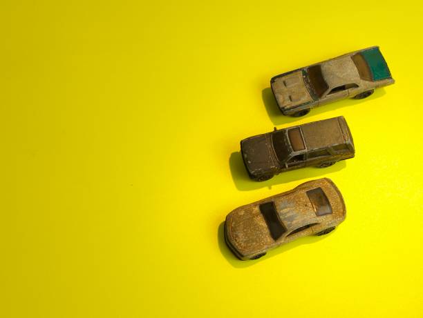istock rusty car toys on yellow background 1476075264