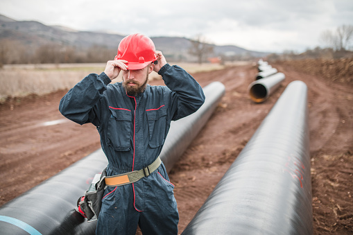 engineer in uniform controlling the operation of a gas pipeline