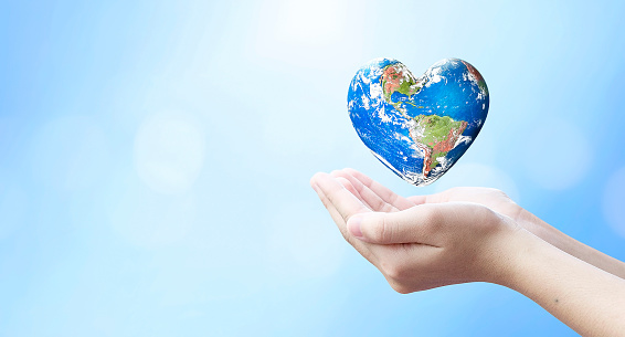 world health day and global health care concept,Holding Earth in heart shape hands against natural background, Elements of this image furnished by NASA