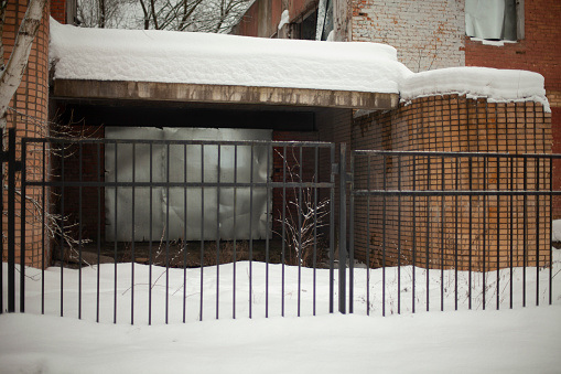 A compost and a garden work bench during winter with snow covered pots.You might also like