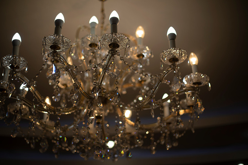 Elegant luxurious glass chandelier hanging from ceiling