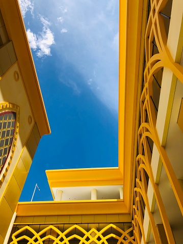 Central Sulawesi, Indonesia - March 24, 2023 : yellow campus building with beautiful blue clouds