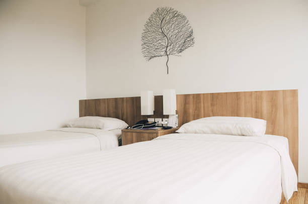 istock bed made with white linens in the hotel 1476084227