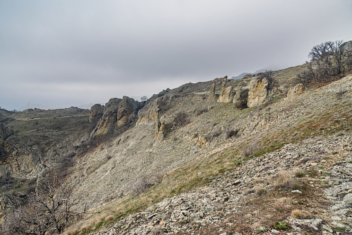 Gingerbread horse rock and bizarre rocks in Dead city. Khoba-Tele Ridge of Karadag Reserve in early spring. Crimea