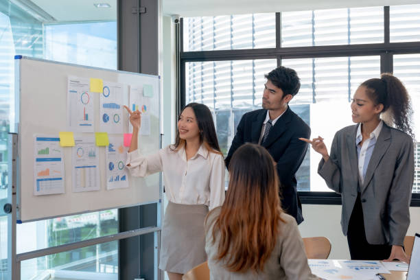 istock Group of young Asian business creative development planning strategy meeting and presentation at company sales strategy marketing conference. 1476090835