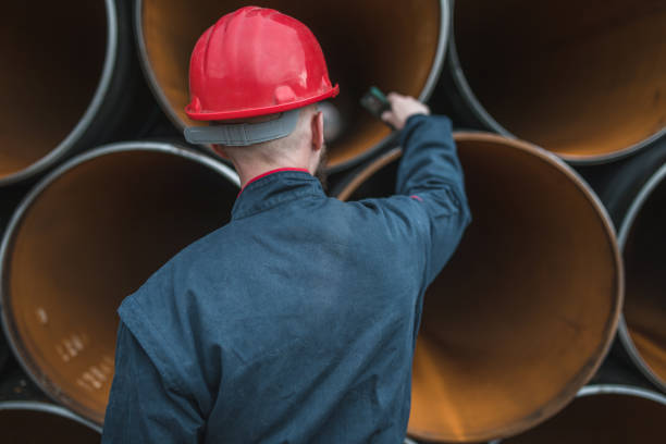 istock Rear view of an engineer using a pipe measuring device for a gas pipeline 1476092654