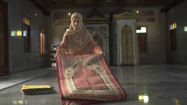 4K Muslim Woman Preparing Sajadah Carpet For Prayers In Mosque