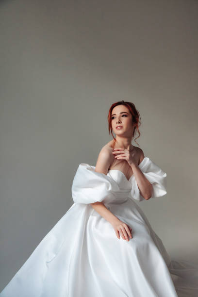 Fashionable german bride young pretty lady wear white wedding dress, looking away. Stylish cute cover brunette woman posing at grey background. Fashion trendy style beauty concept. Copy ad text space Fashionable german bride young pretty lady wear white wedding dress, looking away. Stylish cute cover brunette woman posing at grey background. Fashion trendy style beauty concept. Copy ad text space vogue cover stock pictures, royalty-free photos & images