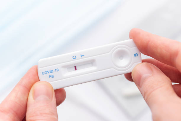 istock Hand holding a negative result for COVID-19 1476096850