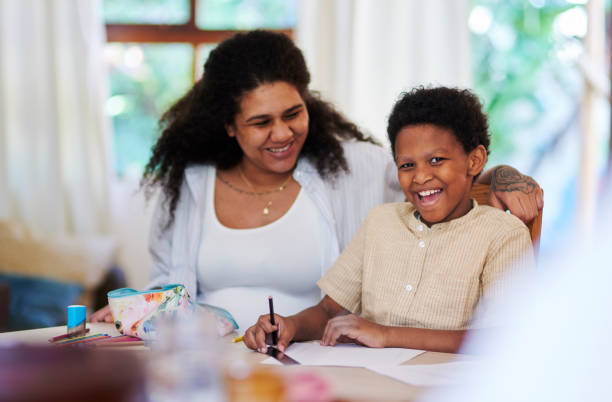 istock Family home, learning and mother with child education, teaching and happy writing development. black woman or mom with kid for language, creative knowledge and support, helping and excited portrait 1476098507