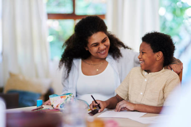 istock Happy family, learning and mother with child education, teaching and creative writing development. Black woman, mom and kid language, drawing support or kindergarten homework and homeschool helping 1476098510