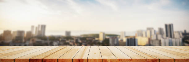 istock Wood table top on white bokeh blurred city sunset background building hallway for display or montage mock up products Blurred dark night city background on perspective wooden panels blur glass window. 1476098964