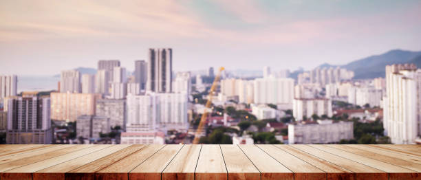 istock Wood table top on white bokeh blurred city sunset background building hallway for display or montage mock up products Blurred dark night city background on perspective wooden panels blur glass window. 1476098975