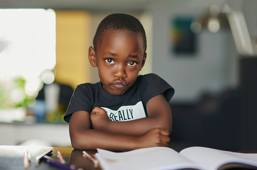 Child, stress or sad portrait with books dyslexia, education crisis or learning disorder in homeschool. Bored, anxiety or black kid with studying depression, notebook or autism and grumpy expression