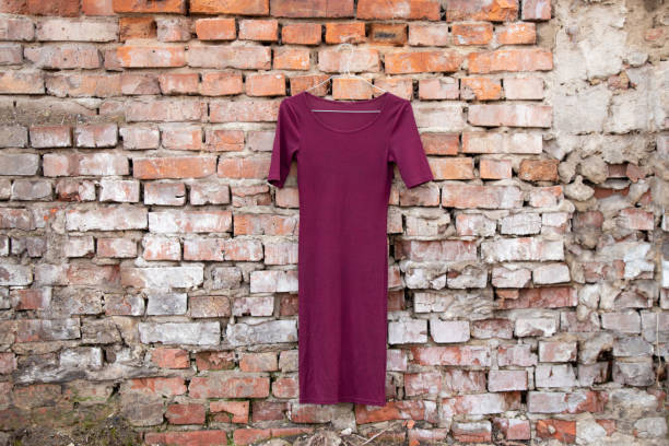 istock red womens dress hanging on a brick old wall outside 1476100595