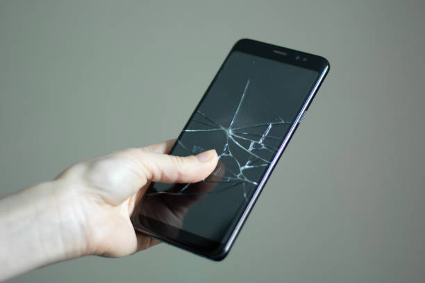 istock black touchscreen phone with a broken screen in the girl's hand close up 1476101352