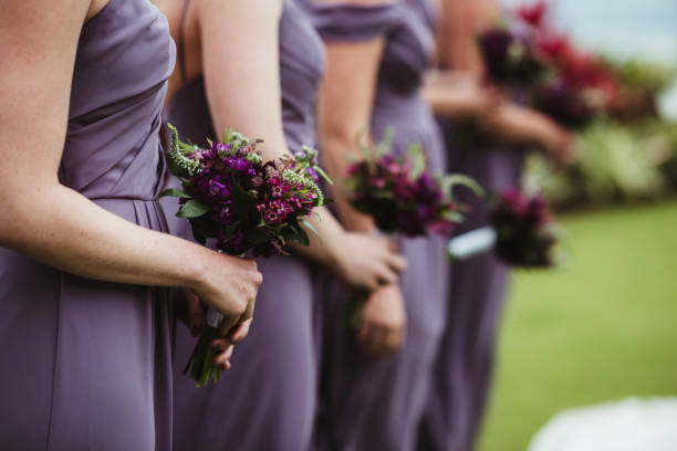 istock Bridesmaids at a wedding ceremony holding flower bouquets 1476109294