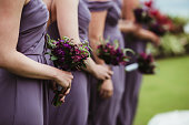 Bridesmaids at a wedding ceremony holding flower bouquets