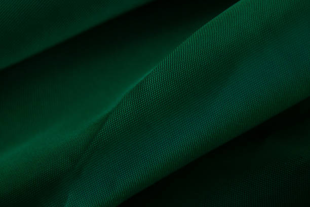 istock dark green wavy fabric as background close up 1476110831